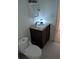 Cozy bathroom with a granite-topped vanity and efficient toilet, maximizing space in a compact design at 1465 Dirty Branch Rd., Conway, SC 29527