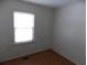 Bright bedroom featuring wood-look flooring and a window allowing natural light to fill the space at 1465 Dirty Branch Rd., Conway, SC 29527