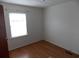 Bright bedroom featuring wood-look flooring and a window allowing natural light to fill the space at 1465 Dirty Branch Rd., Conway, SC 29527