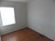 Bright bedroom featuring wood-look flooring and a window allowing natural light to fill the space at 1465 Dirty Branch Rd., Conway, SC 29527