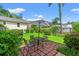 Backyard patio with a table, chairs, umbrella and privacy created by lush greenery and landscaping at 1506 7Th Ave., Conway, SC 29526