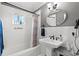 Bright bathroom featuring a pedestal sink, subway tile, and a shower-tub combo with window at 1506 7Th Ave., Conway, SC 29526