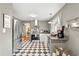 Updated kitchen features stainless steel appliances and black and white checkered flooring at 1506 7Th Ave., Conway, SC 29526