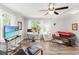 Bright living room features hardwood floors, ceiling fan and dedicated work space at 1506 7Th Ave., Conway, SC 29526
