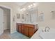 Bright bathroom featuring a double sink vanity, large mirror and ample lighting at 1524 Culbertson Ave., Myrtle Beach, SC 29577