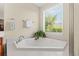 Relaxing bathroom featuring a soaking tub with natural light streaming through the window at 1524 Culbertson Ave., Myrtle Beach, SC 29577