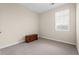 This is a well-lit bedroom with neutral walls and carpet, a dresser and a window with blinds at 1524 Culbertson Ave., Myrtle Beach, SC 29577