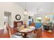 Cozy living room featuring a fireplace, hardwood floors, and dining table at 1524 Culbertson Ave., Myrtle Beach, SC 29577