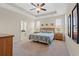 Comfortable primary bedroom with ceiling fan, carpet flooring and natural light at 1524 Culbertson Ave., Myrtle Beach, SC 29577