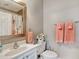 Well-lit bathroom featuring a framed mirror, neutral paint, and coordinated pink towels and accessories at 1533 Lanterns Rest Rd. # 304, Myrtle Beach, SC 29579