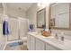 Bathroom featuring double sinks, white cabinets, and shower with glass door at 1533 Lanterns Rest Rd. # 304, Myrtle Beach, SC 29579