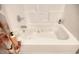 Relaxing bathtub with hydrotherapy jets, surrounded by clean white tiling and convenient shelving at 1533 Lanterns Rest Rd. # 304, Myrtle Beach, SC 29579
