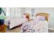 Charming bedroom featuring two twin beds, stylish bedding, wood flooring, and a sunny window at 1533 Lanterns Rest Rd. # 304, Myrtle Beach, SC 29579