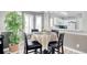 Charming dining area with a round table, black chairs, and a decorative plant near bright windows at 1533 Lanterns Rest Rd. # 304, Myrtle Beach, SC 29579