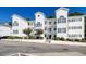 Stylish white condo building featuring multiple balconies, well-maintained landscaping, and a welcoming entrance at 1533 Lanterns Rest Rd. # 304, Myrtle Beach, SC 29579