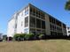 Exterior view of a sunroom featuring a wall of windows and a screened in porch at 1533 Lanterns Rest Rd. # 304, Myrtle Beach, SC 29579