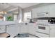 Bright kitchen with white cabinets, modern appliances, and a window overlooking the sink area at 1533 Lanterns Rest Rd. # 304, Myrtle Beach, SC 29579