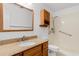 Bathroom featuring wood vanity with granite top, a large mirror, and a convenient shower-tub combo with grab bars at 1851 Colony Dr. # 4-F, Surfside Beach, SC 29575