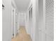 Bright hallway features tile flooring and leads to a white door at the end at 1851 Colony Dr. # 4-F, Surfside Beach, SC 29575
