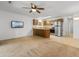 Open living area with ceiling fan, television and view to kitchen at 1851 Colony Dr. # 4-F, Surfside Beach, SC 29575