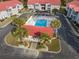 Aerial view of the pool, cabana, landscaping, and parking areas within the community at 193 Charter Dr. # E-2, Longs, SC 29568