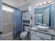 Updated bathroom with modern fixtures, storage cabinet, and shower-tub combination at 193 Charter Dr. # E-2, Longs, SC 29568