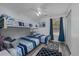 This bright bedroom features a bunk bed, a twin bed, a ceiling fan, and blue striped bedding at 193 Charter Dr. # E-2, Longs, SC 29568