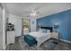Comfortable bedroom features calming blue accent wall and decorative bench at the foot of the bed at 193 Charter Dr. # E-2, Longs, SC 29568