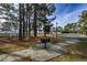 Outdoor community grill perfect for entertaining, on a concrete pad with surrounding trees at 193 Charter Dr. # E-2, Longs, SC 29568