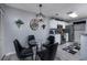 Eat-in-kitchen dining area features modern light fixture and glass table at 193 Charter Dr. # E-2, Longs, SC 29568