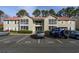 Well-maintained condo building featuring private balconies, manicured landscaping, and convenient parking at 193 Charter Dr. # E-2, Longs, SC 29568