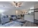 Open living room with a large sectional, modern fan, and view into kitchen/dining area at 193 Charter Dr. # E-2, Longs, SC 29568