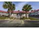 Community pool cabana and restrooms, surrounded by lush palm trees and green grass at 193 Charter Dr. # E-2, Longs, SC 29568