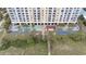 Aerial view of the resort with multiple pools, sun loungers, palm trees, and a boardwalk leading to the beach at 2000 N Ocean Blvd. # 502, Myrtle Beach, SC 29577