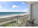 Relax on the balcony with serene ocean views and a comfortable chair at 2000 N Ocean Blvd. # 502, Myrtle Beach, SC 29577