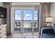 Step out to the balcony and enjoy ocean views from sliding glass doors and neutral-toned drapes at 2000 N Ocean Blvd. # 502, Myrtle Beach, SC 29577