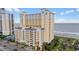 View of the condo complex with a beach view on a sunny day at 2000 N Ocean Blvd. # 502, Myrtle Beach, SC 29577