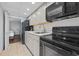 Galley kitchen featuring black appliances, gray cabinets, and a tile floor at 2000 N Ocean Blvd. # 502, Myrtle Beach, SC 29577