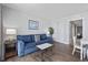 Comfortable living room with a cozy blue sofa, adjacent dining area, and natural light at 2000 N Ocean Blvd. # 502, Myrtle Beach, SC 29577