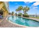 Refreshing outdoor pool with beautiful palm trees providing a tropical resort ambiance at 2000 N Ocean Blvd. # 502, Myrtle Beach, SC 29577