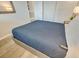 Close-up of a queen bed featuring a blue quilt in a bedroom with warm, ambient lighting at 2310 N Ocean Blvd. # 308, Myrtle Beach, SC 29572