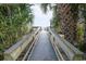 Wooden boardwalk leading to a scenic beach with palm trees at 2310 N Ocean Blvd. # 308, Myrtle Beach, SC 29572