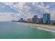 Beautiful coastal view of buildings with a beach in the foreground on a sunny day at 2310 N Ocean Blvd. # 308, Myrtle Beach, SC 29572