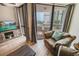 Relaxing living space with comfy seating, a flatscreen TV, and scenic views through the window at 2310 N Ocean Blvd. # 308, Myrtle Beach, SC 29572