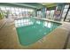Indoor pool with large windows and comfortable lounge seating at 2310 N Ocean Blvd. # 308, Myrtle Beach, SC 29572
