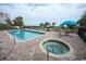 Outdoor pool and hot tub area with chairs and umbrellas at 2310 N Ocean Blvd. # 308, Myrtle Beach, SC 29572