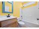 Bright yellow bathroom with yellow walls, vanity, toilet and shower/tub combination at 237 Copperwood Loop, Conway, SC 29526