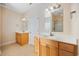 Well-lit bathroom with double vanities, large mirrors, and a shower at 237 Copperwood Loop, Conway, SC 29526