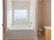 Cozy bathroom featuring a soaking tub under a bright window at 237 Copperwood Loop, Conway, SC 29526