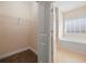 An open walk-in closet with a view into the ensuite bathroom at 237 Copperwood Loop, Conway, SC 29526